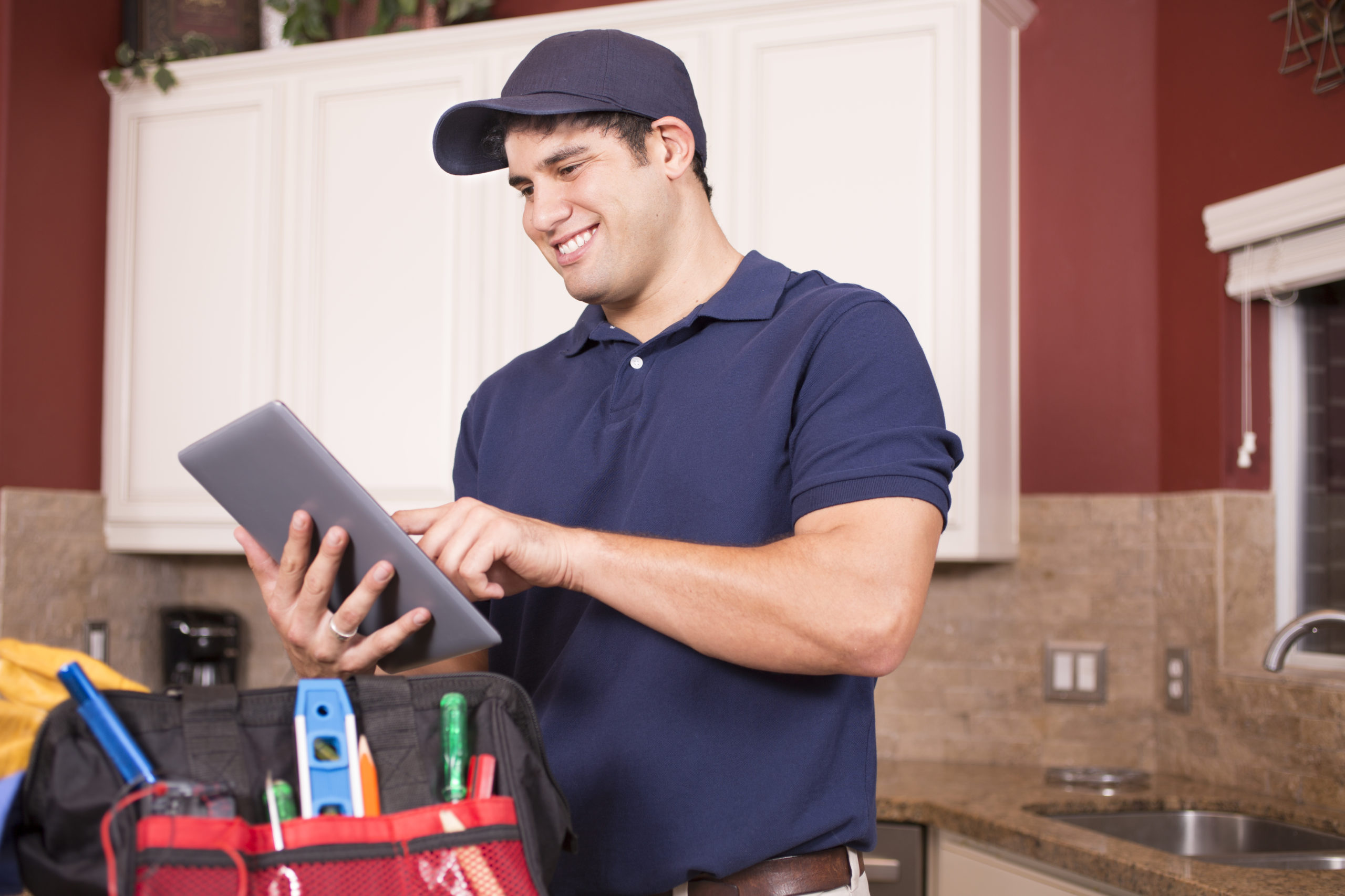 Repairman working inside customer’s home.