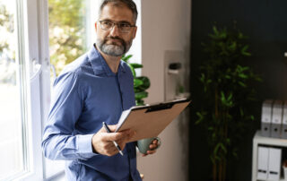 an inspector performing an fha home inspection and appraisal, clipboard in hand