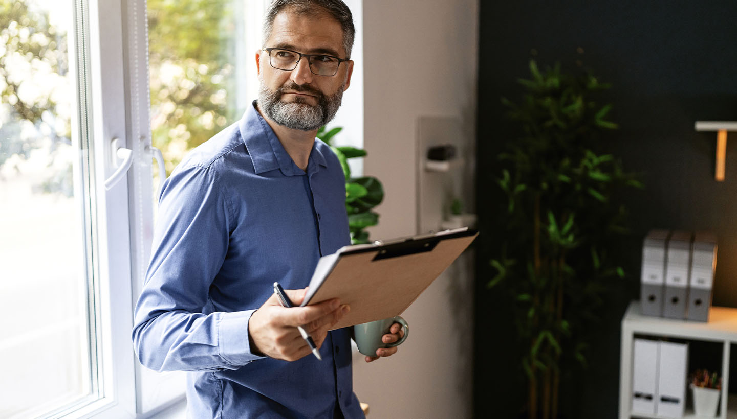 an inspector performing an fha home inspection and appraisal, clipboard in hand